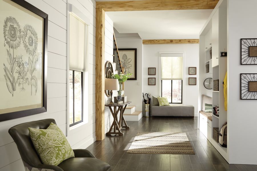 A home's hallway with sunlight filtering through Lutron's halfdrawn automated shades.