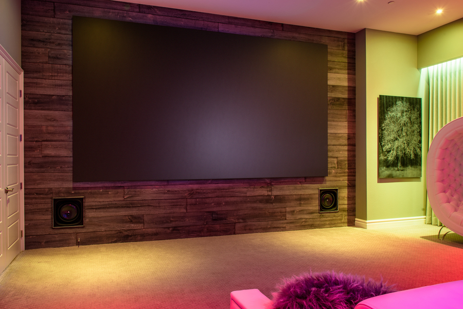a home theater with a large screen TV and speakers installed inside the walls