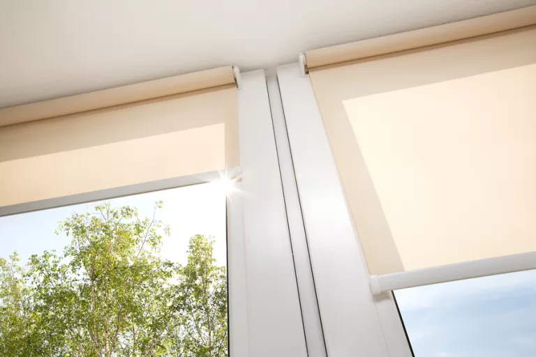 Closeup of two partially rolled up automated shades.