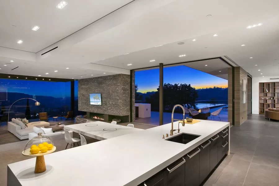A large open kitchen and living area with in-ceiling speakers.