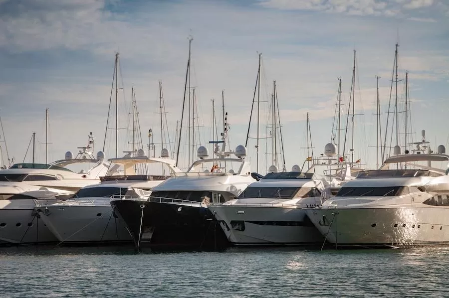 A line of yachts in a marina.