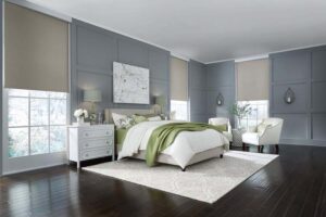 A luxury bedroom with Lutron motorized shades halfway down.