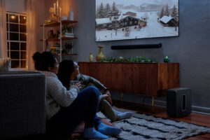 A couple watches a Christmas movie in their media room.