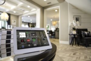 A Control4 touchscreen interface resting on a table.