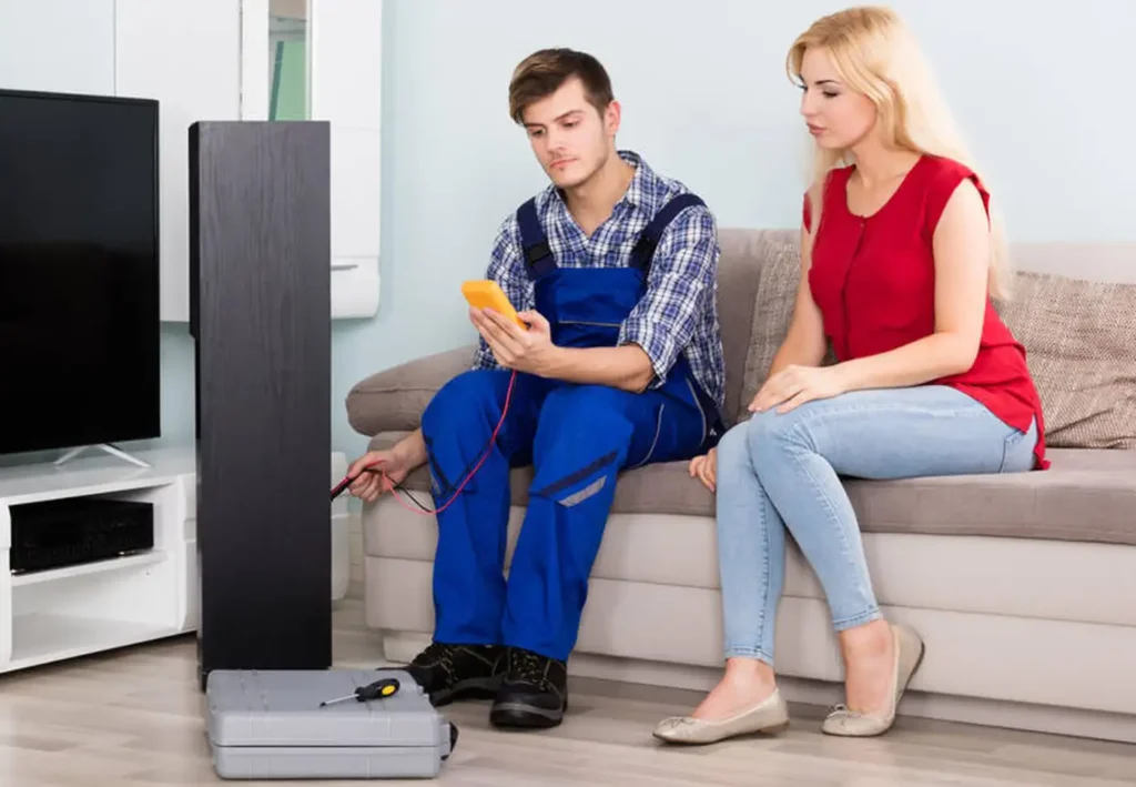 technician helping women with home theater installation